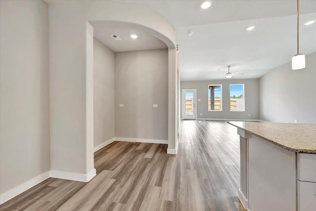 kitchen with hanging light fixtures, hardwood / wood-style floors, and ceiling fan