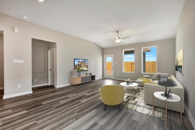 living room with ceiling fan, vaulted ceiling, and dark hardwood / wood-style flooring