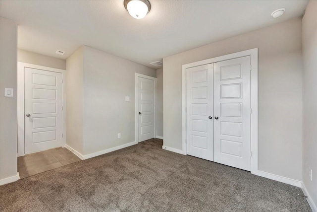 unfurnished bedroom with carpet floors and a closet