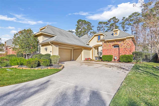 view of front of property with a garage and a front yard