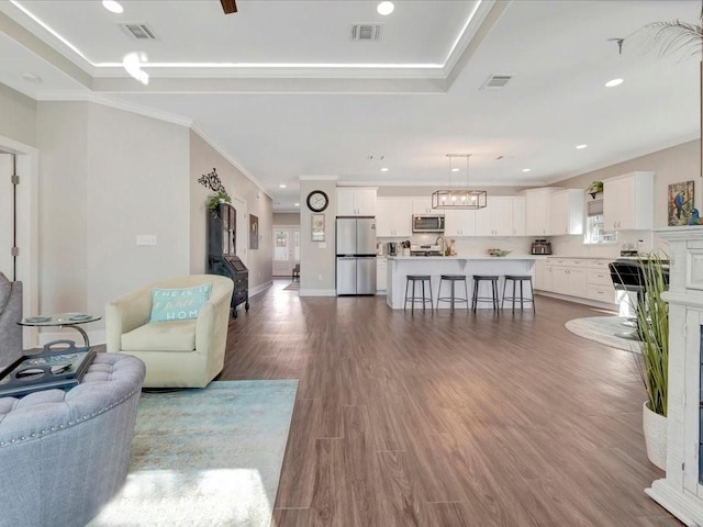 living room with hardwood / wood-style flooring and crown molding