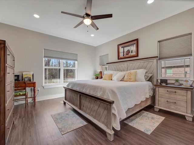 bedroom with crown molding, dark hardwood / wood-style floors, and ceiling fan