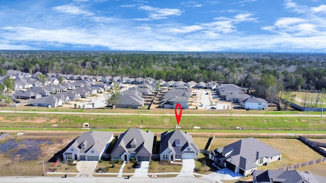 birds eye view of property featuring a residential view and a wooded view