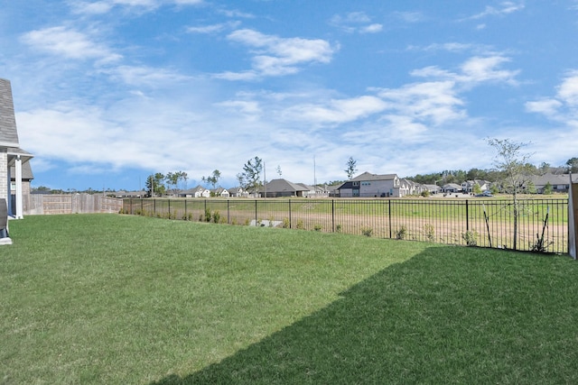 view of yard with a residential view and fence