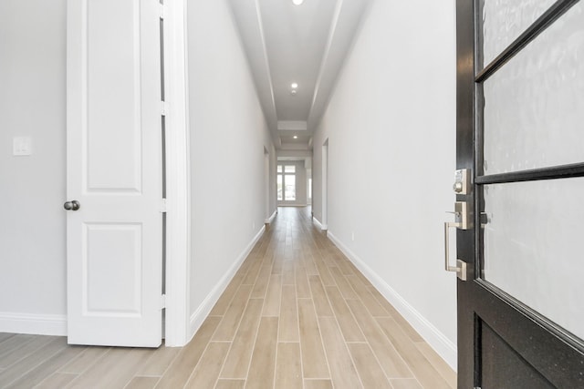 hall featuring recessed lighting, baseboards, and wood finish floors