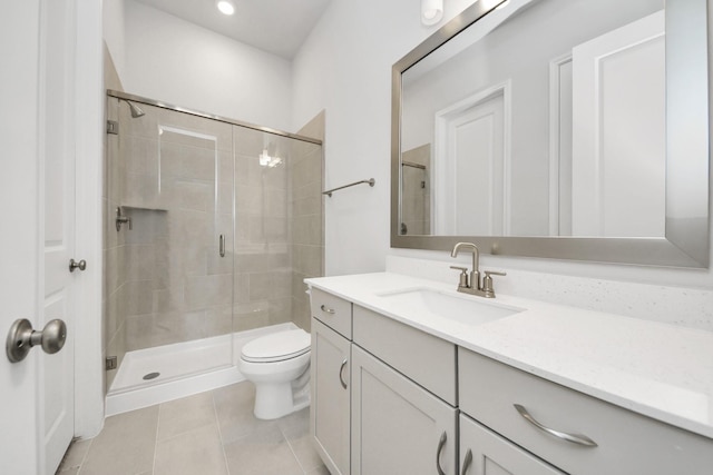 full bath featuring a stall shower, tile patterned flooring, vanity, and toilet