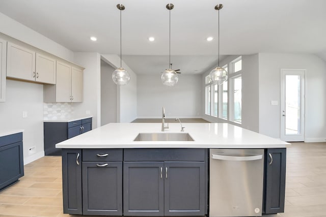 kitchen with a sink, decorative backsplash, dishwasher, and light countertops