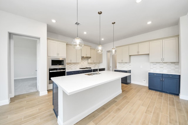 kitchen with visible vents, stainless steel microwave, oven, gas cooktop, and a sink