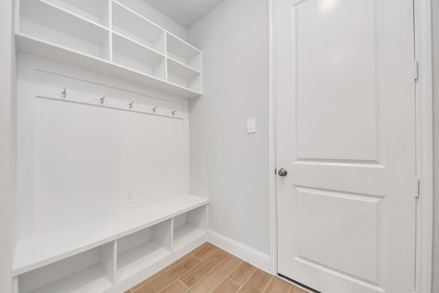 mudroom with wood finish floors and baseboards