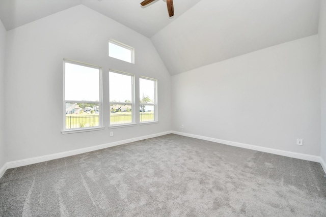 carpeted empty room featuring ceiling fan, baseboards, and vaulted ceiling