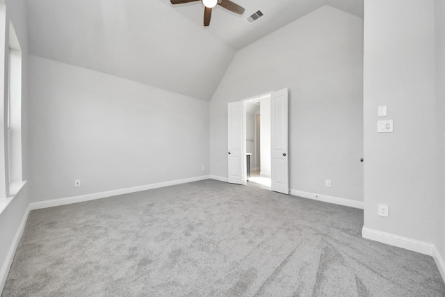 unfurnished bedroom with visible vents, baseboards, a ceiling fan, lofted ceiling, and carpet