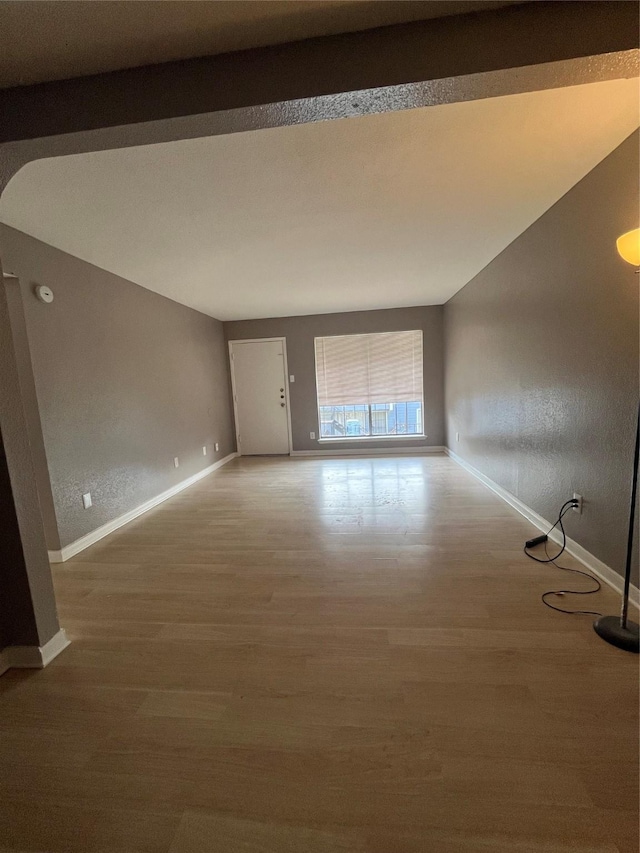 empty room with hardwood / wood-style flooring