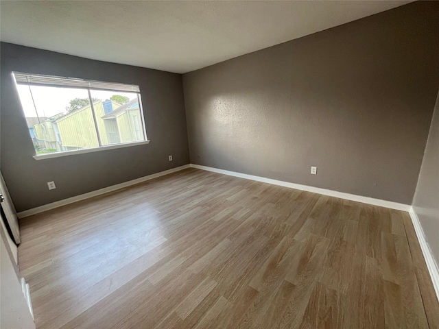 empty room with light hardwood / wood-style flooring