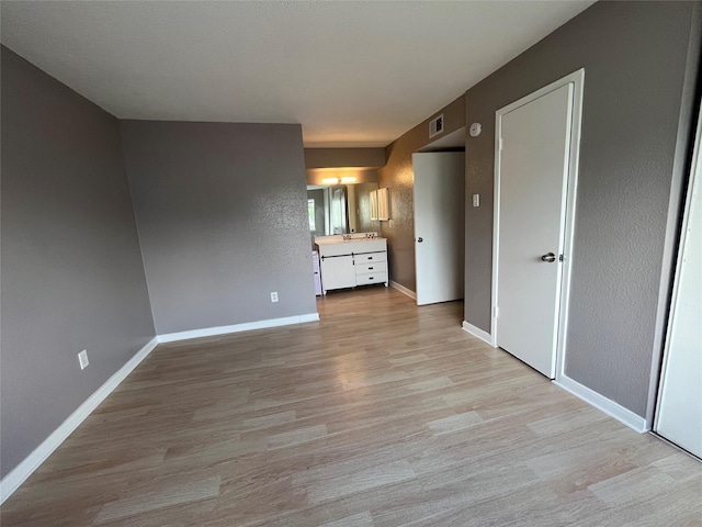 unfurnished bedroom featuring light wood-type flooring