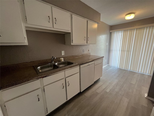 kitchen featuring sink, a textured ceiling, white dishwasher, light hardwood / wood-style floors, and white cabinets