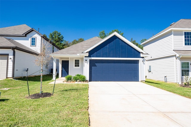 view of front of home with a garage and a front lawn