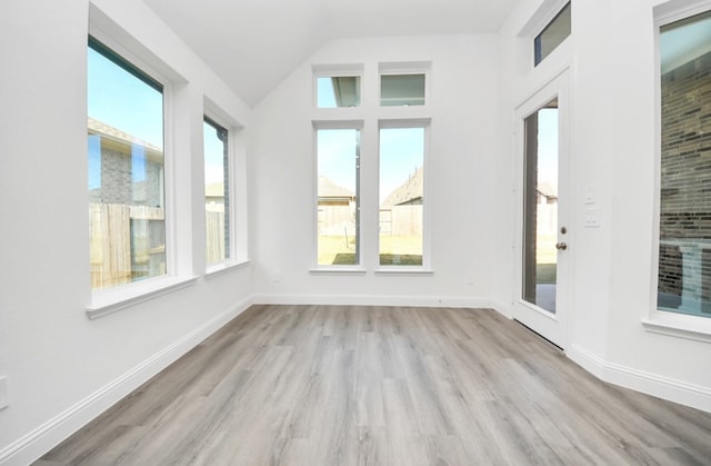 unfurnished sunroom with lofted ceiling and a healthy amount of sunlight