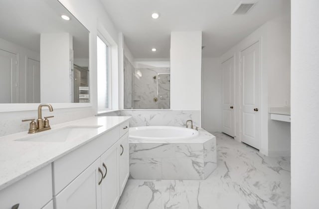 bathroom featuring vanity and plus walk in shower