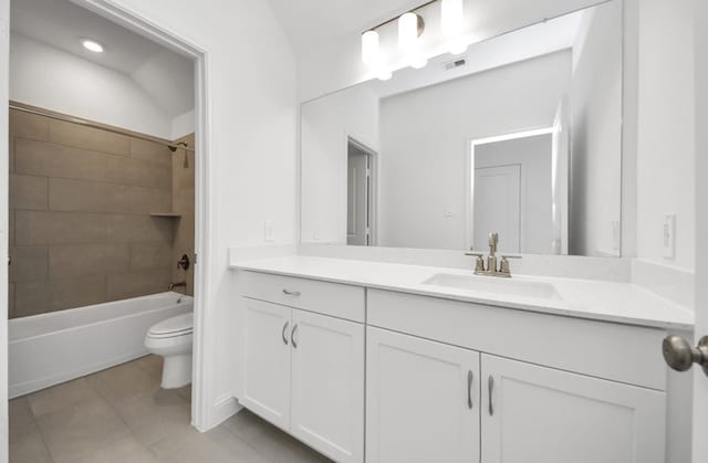 full bathroom with vanity, tiled shower / bath, tile patterned flooring, and toilet