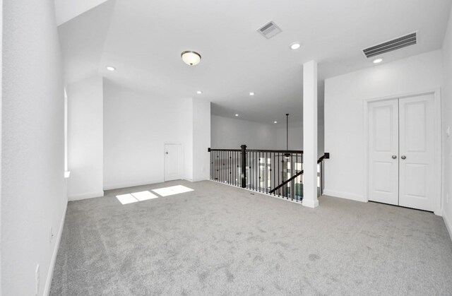 carpeted spare room featuring recessed lighting, visible vents, and baseboards