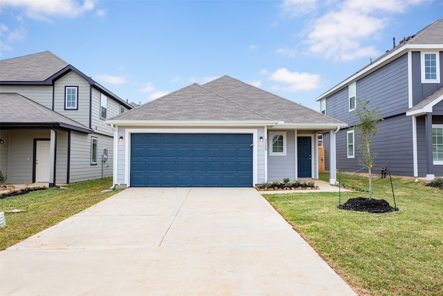 view of property with a garage and a front yard