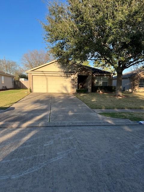 view of front of house featuring a garage and a front lawn