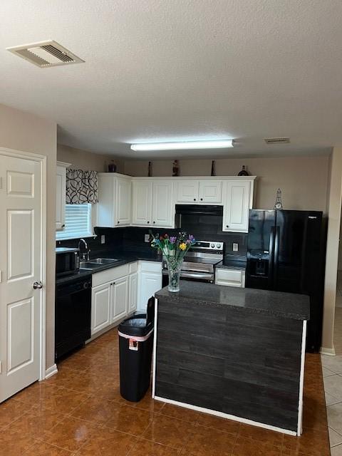 kitchen with sink, white cabinetry, backsplash, range hood, and black appliances