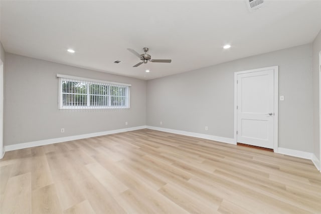 spare room with ceiling fan and light wood-type flooring