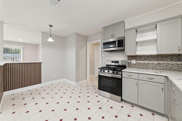 kitchen with tasteful backsplash, stainless steel appliances, gray cabinets, and pendant lighting