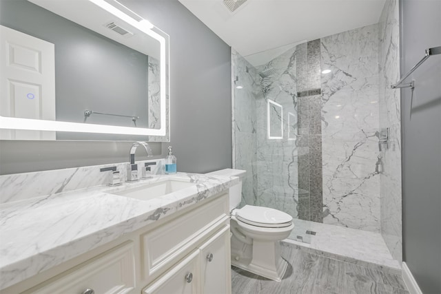 bathroom with toilet, vanity, a marble finish shower, and visible vents