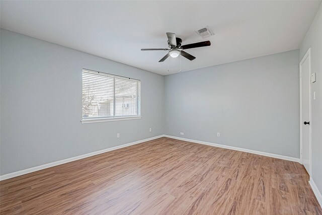 empty room featuring ceiling fan and light hardwood / wood-style floors