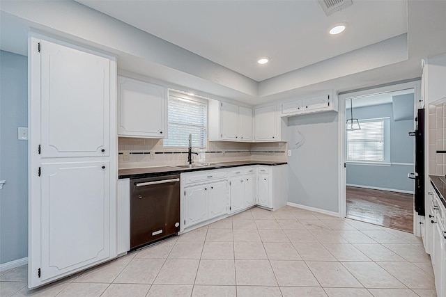 kitchen featuring white cabinetry, stainless steel dishwasher, sink, and light tile patterned floors