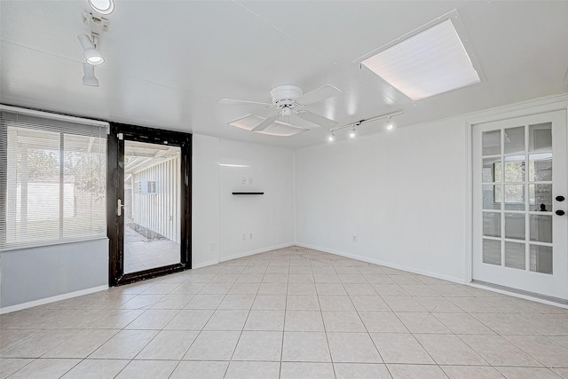 tiled spare room featuring ceiling fan