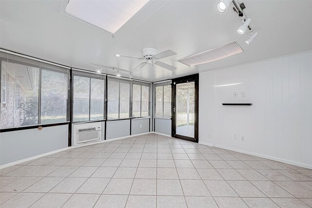 unfurnished room featuring ceiling fan, light tile patterned floors, and an AC wall unit