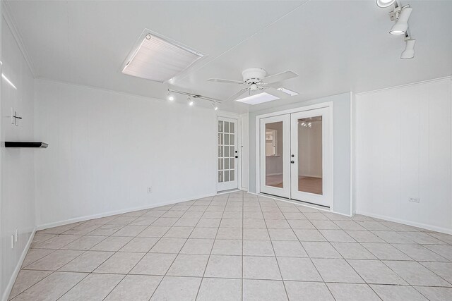 empty room featuring light tile patterned floors, french doors, and ceiling fan