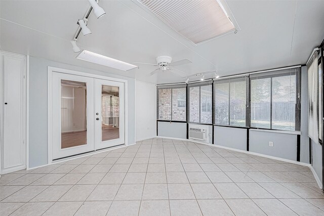 unfurnished sunroom featuring french doors and ceiling fan