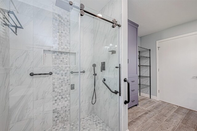 bathroom with a shower with shower door