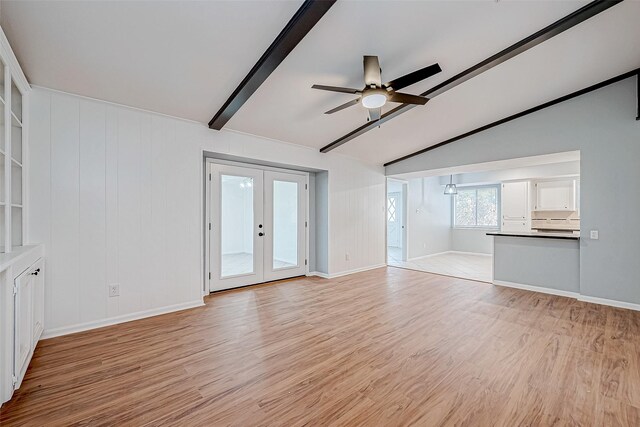 unfurnished living room featuring french doors, ceiling fan, lofted ceiling with beams, and light wood-type flooring