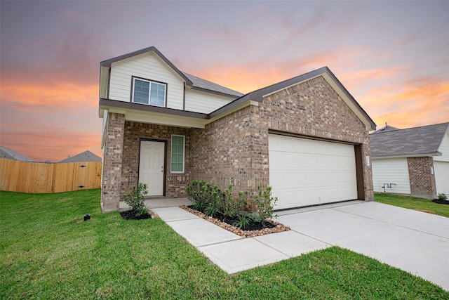 view of front of property featuring a garage and a lawn