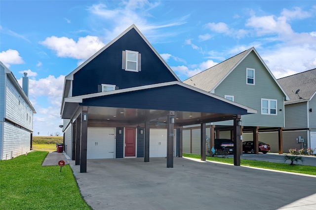 view of front of property featuring a carport, a garage, and a front yard