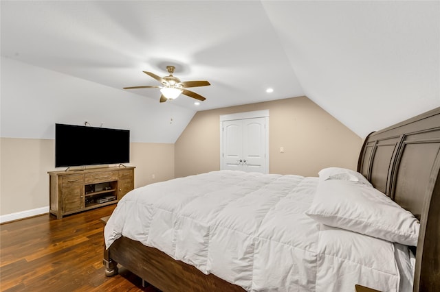 bedroom with dark hardwood / wood-style flooring, lofted ceiling, a closet, and ceiling fan