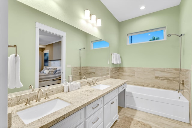 bathroom featuring vanity and a tub