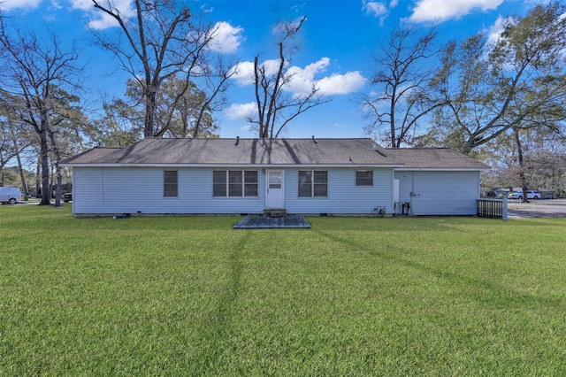 rear view of property featuring a yard