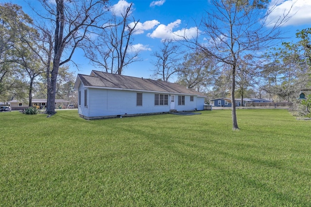 back of property featuring a lawn