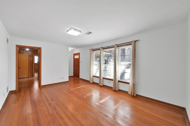 spare room with light hardwood / wood-style floors