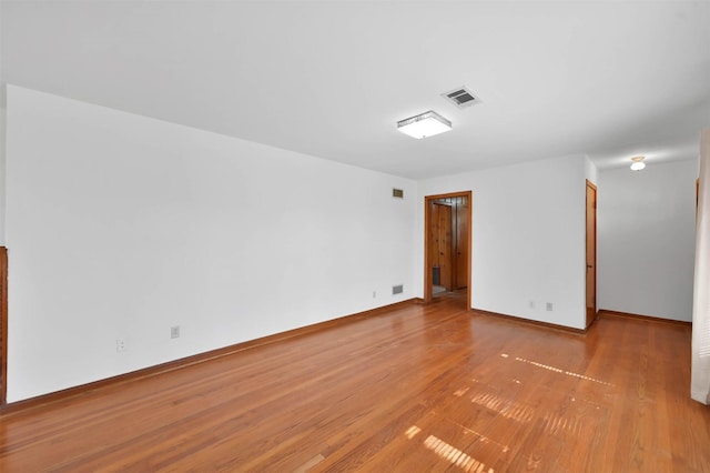 spare room featuring light hardwood / wood-style floors