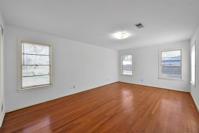 spare room with hardwood / wood-style flooring