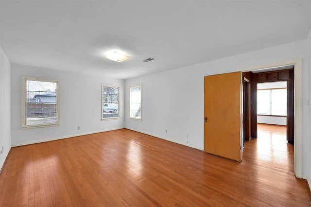 unfurnished room with light wood-type flooring