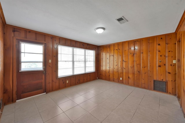 tiled spare room with wooden walls