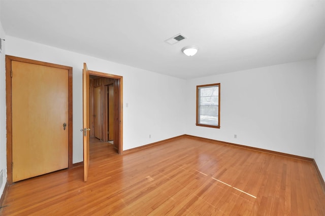 spare room with light wood-type flooring